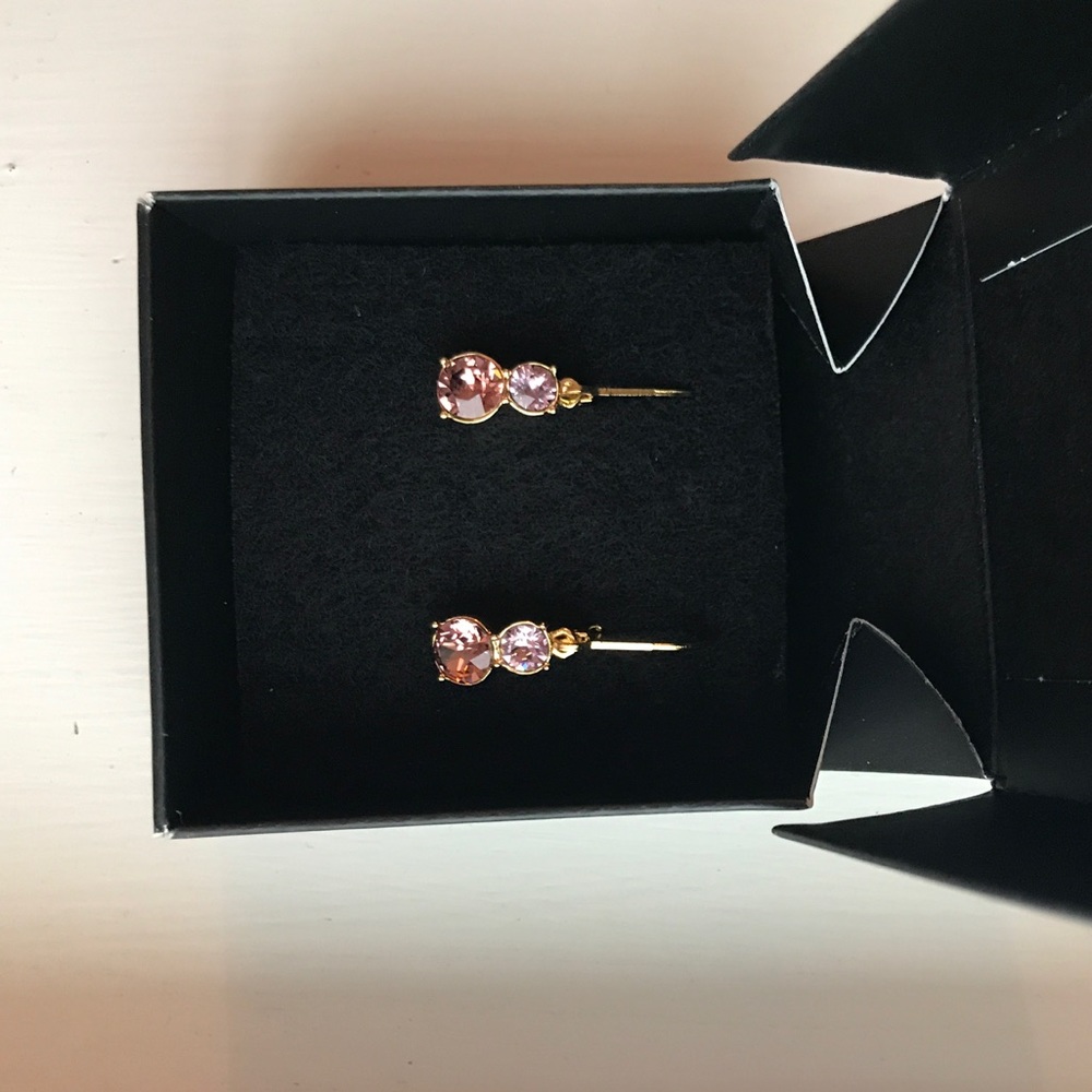 Gold small dangling earrings with pink diamonds.